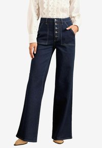 Клешеные джинсы Клешеные джинсы