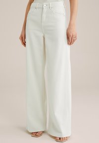 Клешеные джинсы Клешеные джинсы