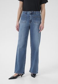 Клешеные джинсы Клешеные джинсы