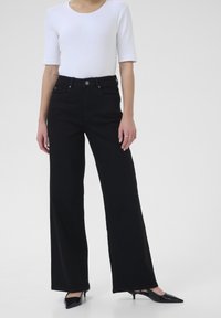 Клешеные джинсы Клешеные джинсы