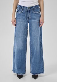 Клешеные джинсы Клешеные джинсы