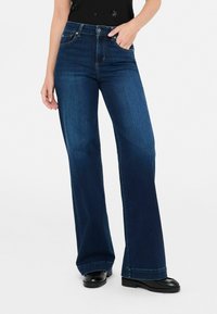 Клешеные джинсы Клешеные джинсы