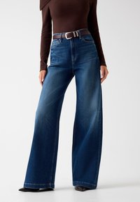 Клешеные джинсы Клешеные джинсы